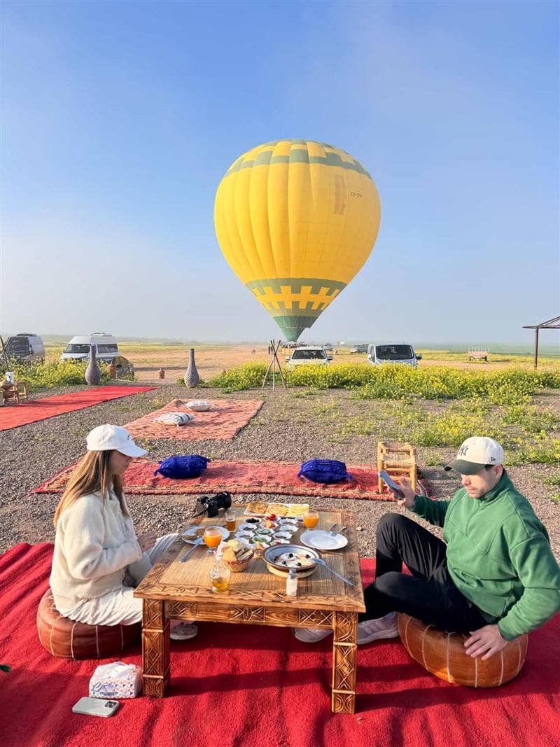 Guests having a Moroccan breakfast next to a yellow balloon