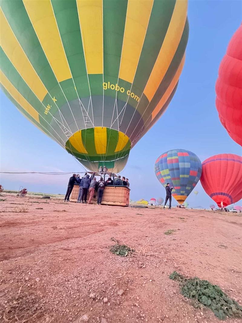 Our crew holding the basket while the hot air balloon fills before sunrise