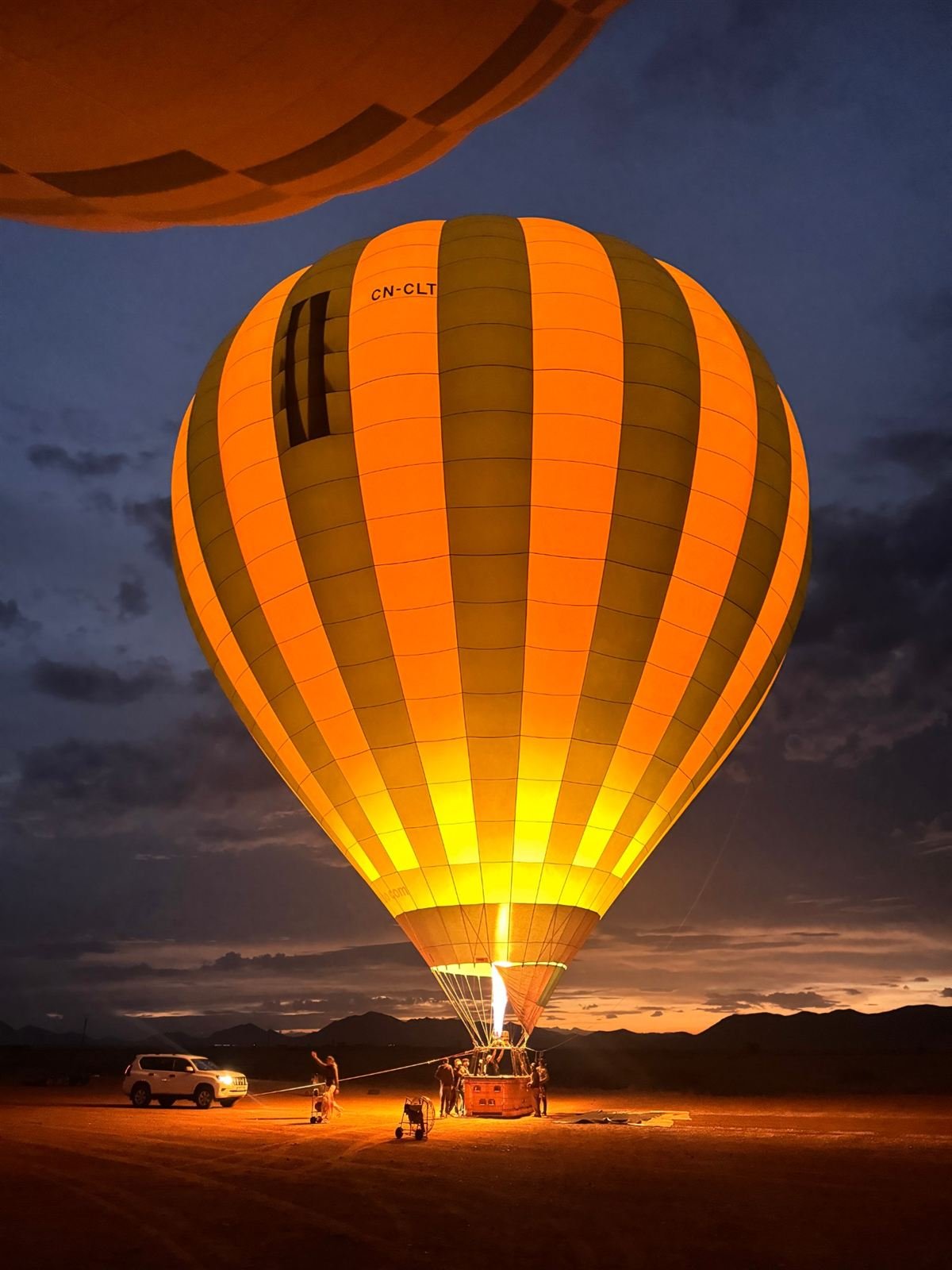 Pilot firing the burner as the balloon stands up on the field