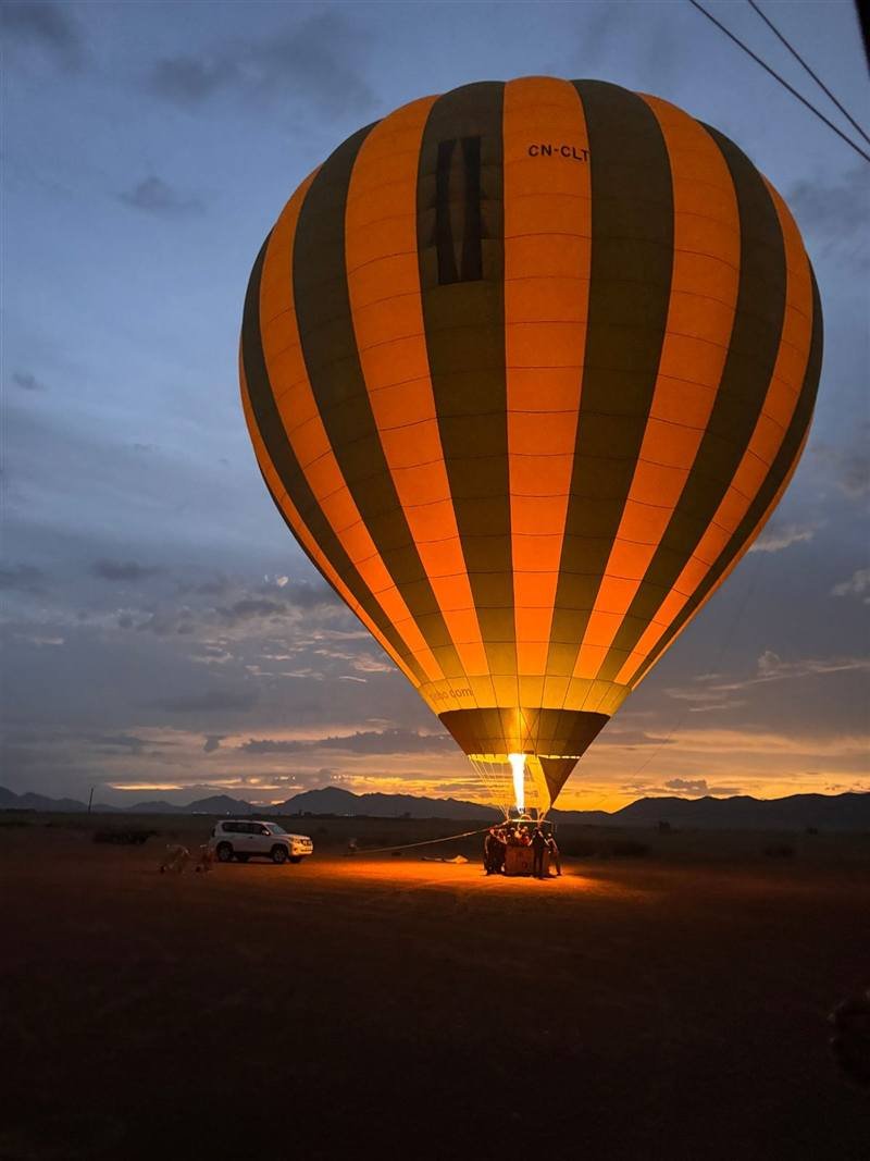 The balloon standing up on the launch field before sunrise